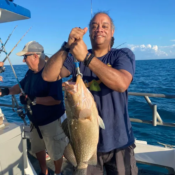 a person holding a fish in the water